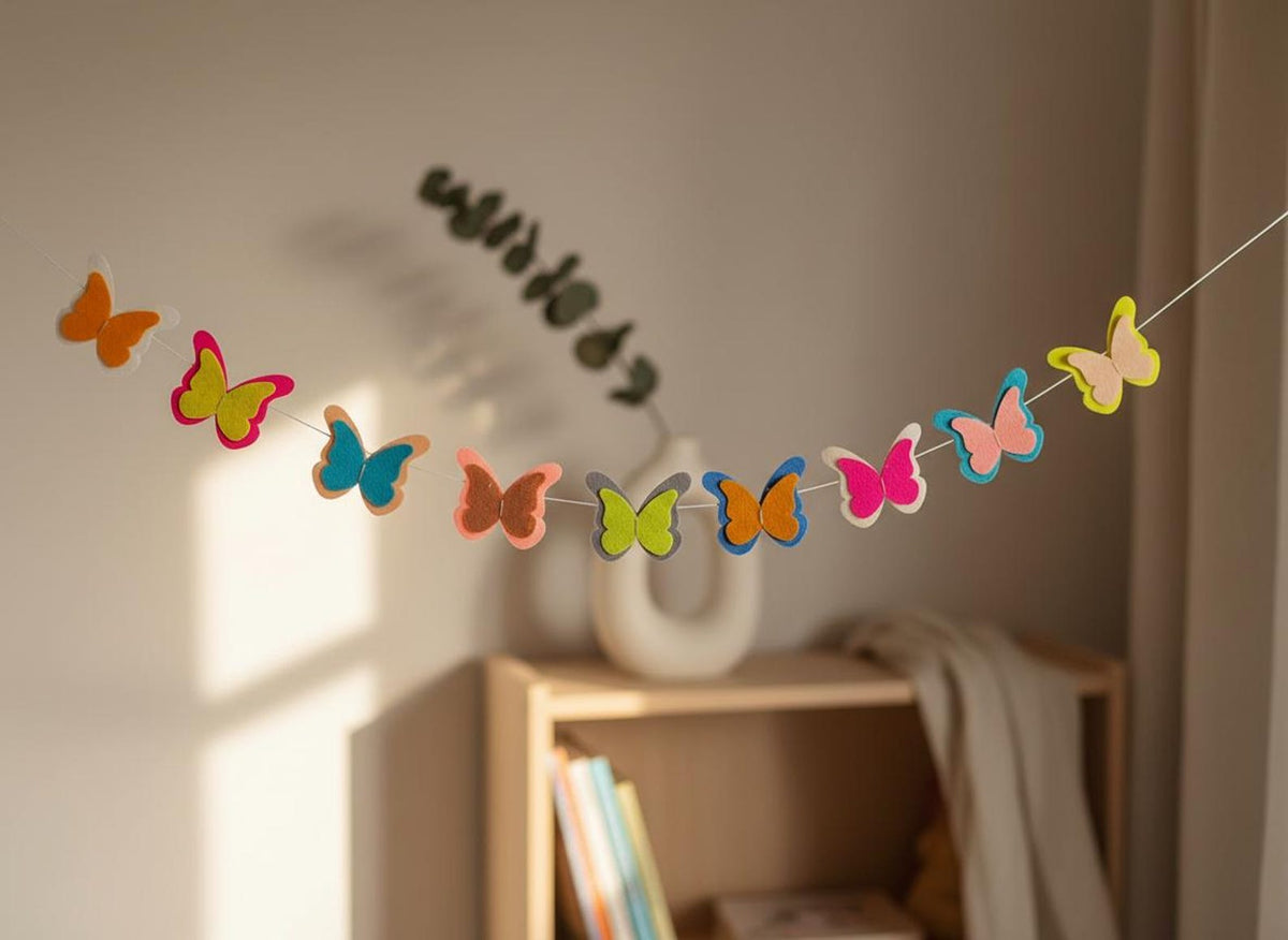 Handmade felt butterfly garland displayed against a neutral wall